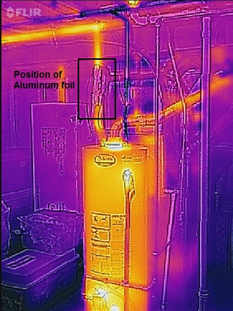 Home water heater. Aluminum foil on vertical hot water feed line